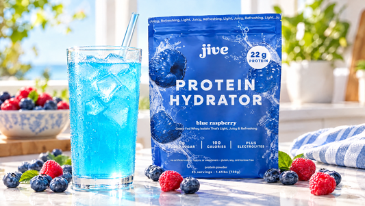 Glass of clear blue protein drink over ice next to Jive Protein Hydrator Blue Raspberry